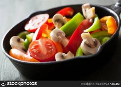 colorful vegetables in black pan ready for frying