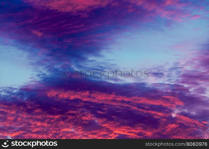 Colorful vibrant clouds on sky at sunset. Romantic and dramatic cloud formation on dusk sky. blue and purple cold landscape with sunlight.