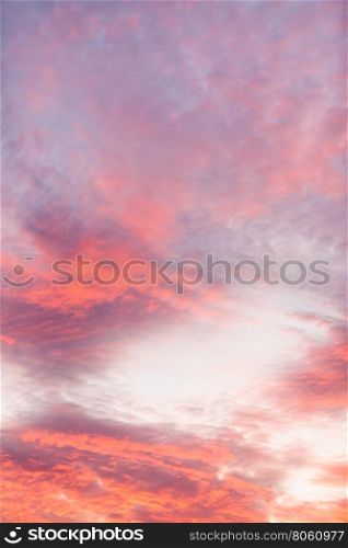 Colorful vibrant clouds on sky at sunset. Romantic and dramatic cloud formation on dusk sky. orange and purple landscape with sunlight.