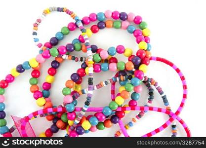 Colorful wood fashion necklaces mess over white background