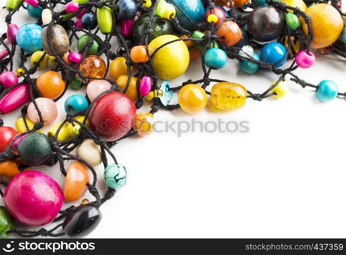 Colorful wooden beads necklace on white background with sample text