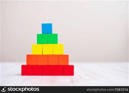 Colorful wooden cube blocks on table background for diverse, multicultural, multiracial, equality and racism concepts