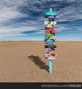 Colorful wooden direction sign with destination countries in empty desert
