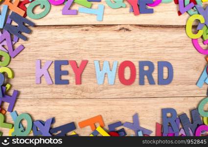 colorful wooden letter of the alphabet and the word Key word isolated on wood background