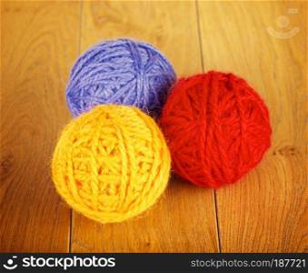 colorful yarn balls lying on wooden background. Colorful Yarn Ball