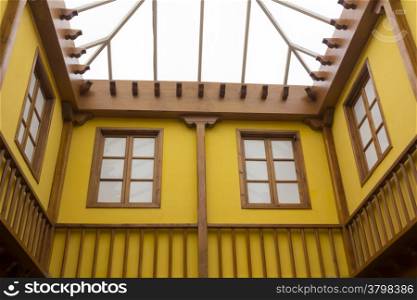 Colorful yellow covered patio and wooden beams
