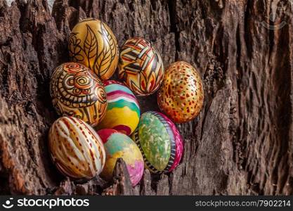 Colorfull easter egg with old brown log