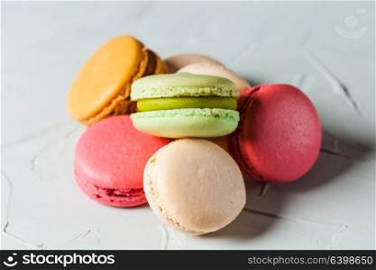 Colorfull macaroons heap close up on gray background. Colorfull macaroons heap