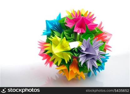 Colorfull origami kusudama from rainbow flowers isolated on white.