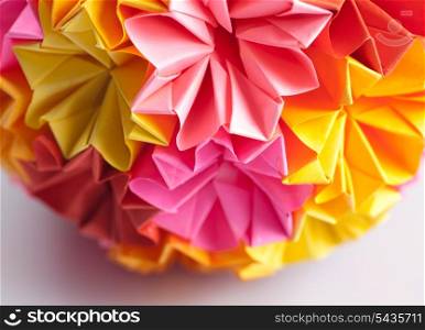 Colorfull origami kusudama from rainbow flowers isolated on white. Shallow DOF