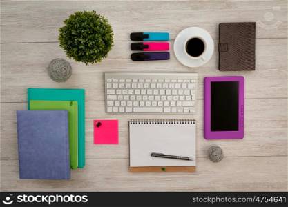 Colorfully business desktop objects on a grey wooden background