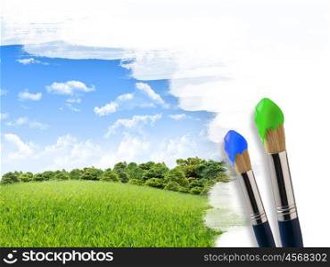 Coloring landscape with blue sky and green grass with a brush.