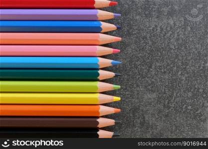 Coloring pencils in many different colors and textured background with copy space for your text.