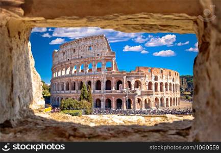 Colosseum of Rome scenic view through stone window, famous landmark of eternal city, capital of Italy