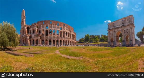 Colosseum or Coliseum in Rome, Italy.. Panorama of The Arch of Titus and Colosseum or Coliseum, also known as the Flavian Amphitheatre, the largest amphitheatre ever built, in the centre of the old city of Rome, Italy.