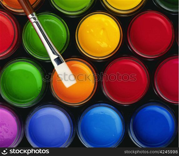 colour paint buckets and a paintbrush