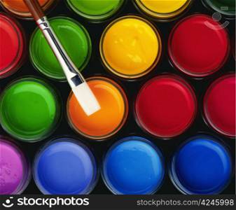 colour paint buckets and a paintbrush
