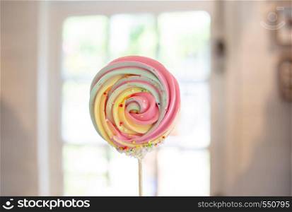 colour sweet meringue candy dessert with wood stick homemade on kitchen house background (include path)