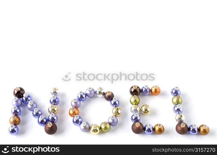 Coloured Baubles Spelling Out Word Noel Against White Background