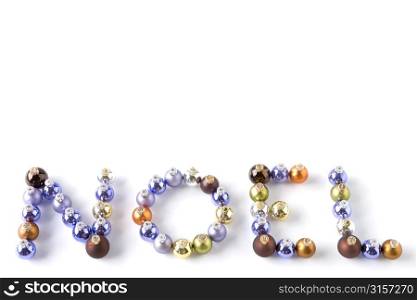Coloured Baubles Spelling Out Word Noel Against White Background