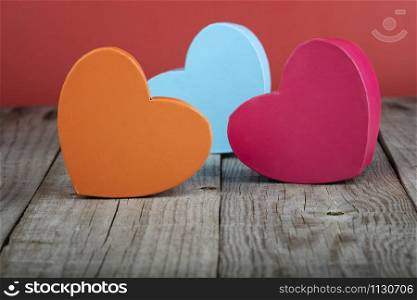 coloured heart shaped gift boxes on a wooden base. valentine&rsquo;s day concept