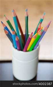 Coloured pencils in a desk tidy