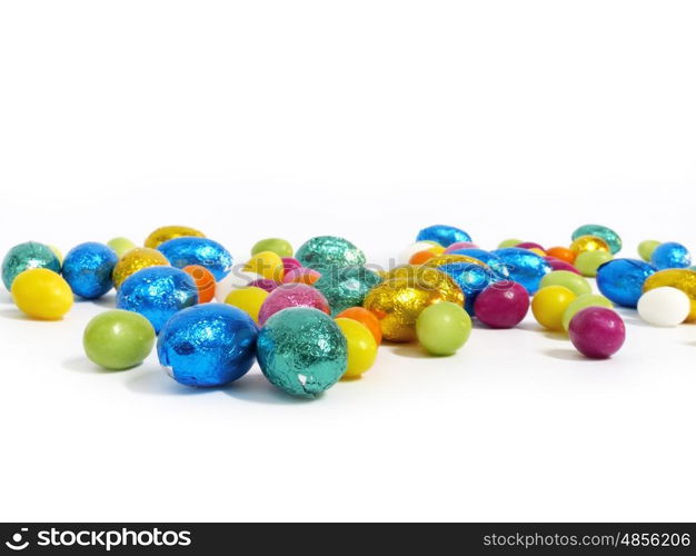 Coloured sugar eggs on white background.. Coloured sugar eggs on white background