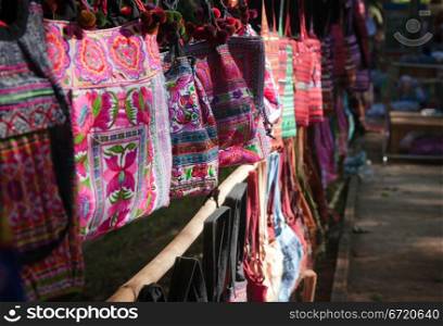 colourful bags hanging in a row for sale