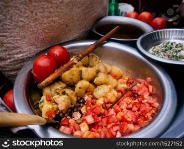 Colourful Bangladesh street food with tomato, beans and potato. South Asian Indien vegetarian cuisine