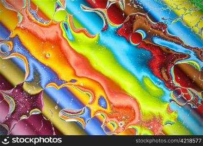 Colourful crayons seen through a water splash