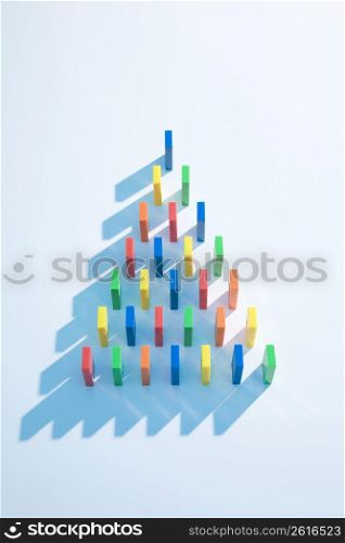 Colourful dominoes making a triangle shape from an aerial view