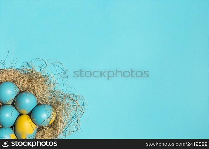 colourful easter eggs big nest blue table