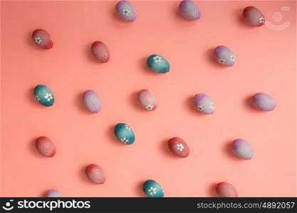 Colourful Easter Eggs ordered on a pink background