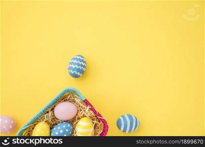colourful easter eggs small basket yellow table. Resolution and high quality beautiful photo. colourful easter eggs small basket yellow table. High quality beautiful photo concept