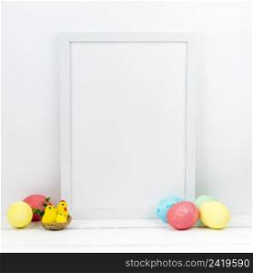 colourful easter eggs with blank frame table