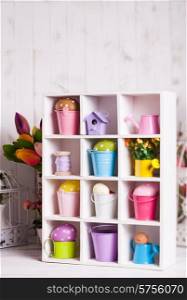 Colourful Eggs in miniature buckets and cans in shadowbox. Spring and Easter decor. Easter box