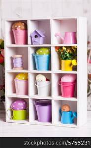 Colourful Eggs in miniature buckets and cans in shadowbox. Spring and Easter decor. Easter box