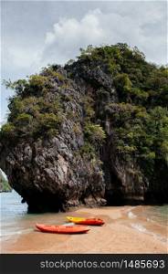 Colourful Kayak boats at Rock island of Koh Talabeng near Koh Lanta, Krabi, Thailand. Summer outdoor water sport