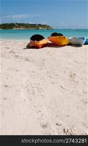 colourful kayaks on a white sandy beach, Long Bay in Antigua