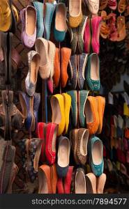 Colourful leather shoes on display in a bazaar in the Medina of Marrakech, Morocco.