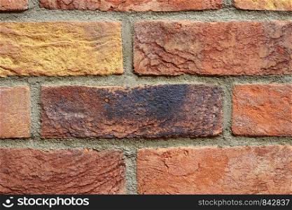 Colourful old brick wall texture background pattern.