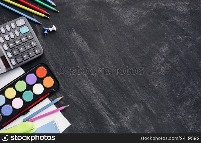 colourful paints calculator pencils grey background