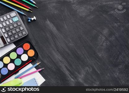 colourful paints calculator pencils grey background