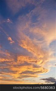 Colourful sunset, yellow and orange clouds, vertical frame