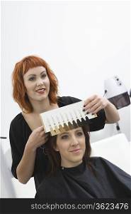 Colourist and client choose shades of colour