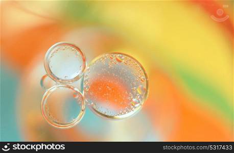 Colrful background with oil bubbles in water