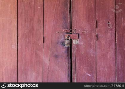 colsed old red wooden door in Thailand