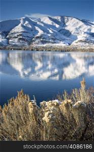 Columbia River Flows After Fresh Snow beneath Mountain Peaks and Homesteads