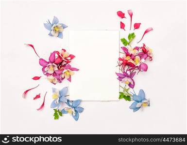 Columbines flower wreath with empty skatchbook. Flat lay background