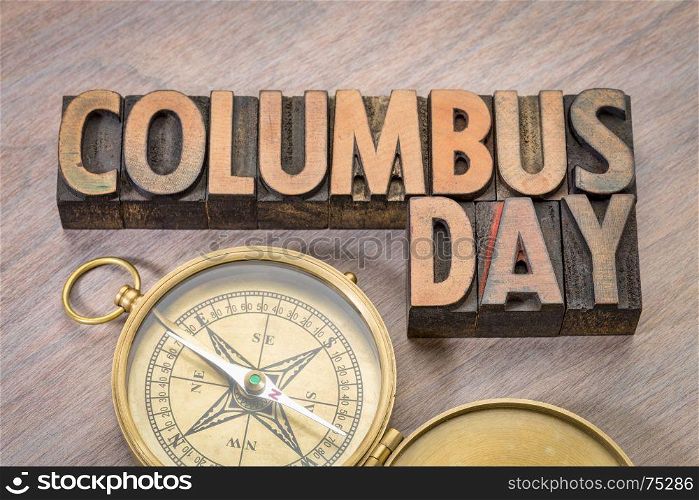 Columbus Day word abstract in vintage letterpress wood type with antique compass